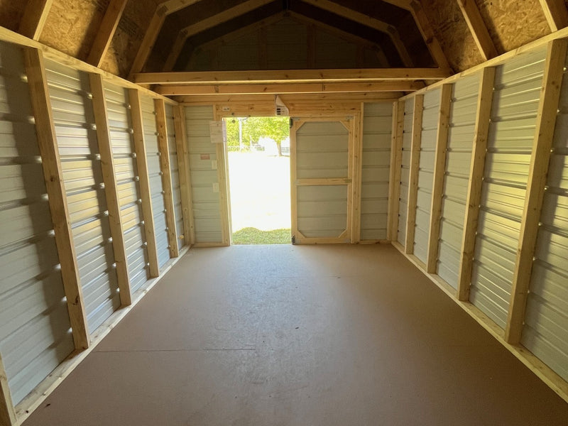 Outland Trailers 10x16 metal lofted barn with steel roof, side door, and vented windows for durable outdoor storage.