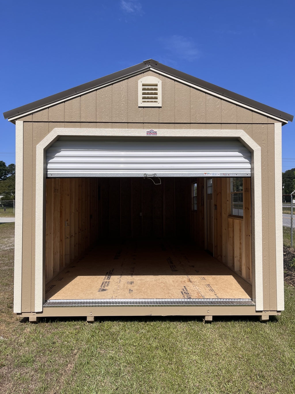 Outland Trailers 12x24 garage with metal walls and roof, double doors, and side vents for durable storage and workspace.