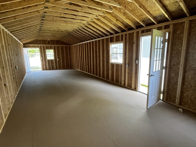 Outland Trailers 14x40 tiny home shell showing wooden exterior walls and door framing for compact, portable living space.