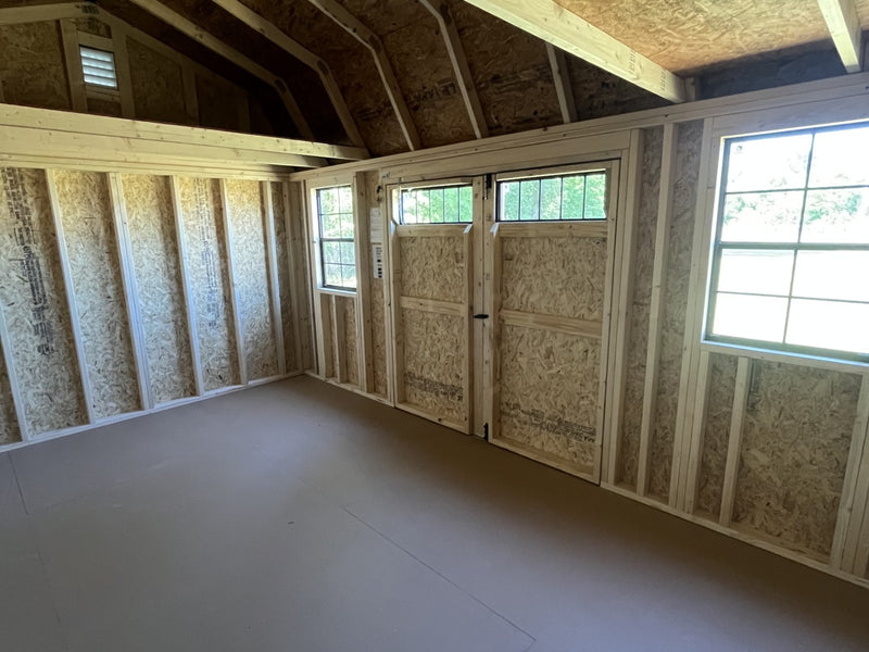 Outland Trailers 10x16 side lofted barn shed with double doors and side windows, showcasing durable wooden construction.