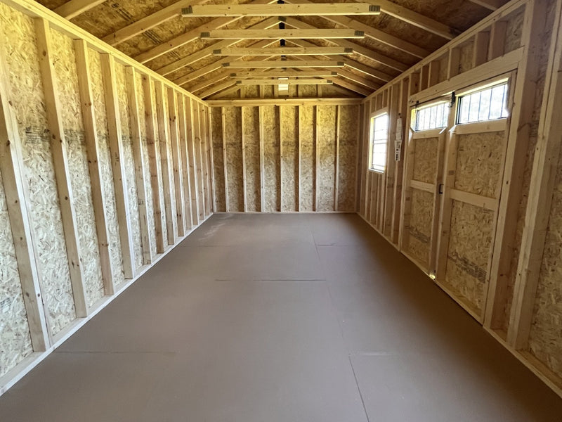 Outland Trailers 12x24 side utility shed with double doors and metal exterior, ideal for storage and outdoor use.