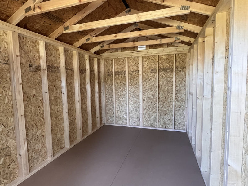 Outland Trailers 8x12 garden shed with double doors and window, made of durable weather-resistant materials.