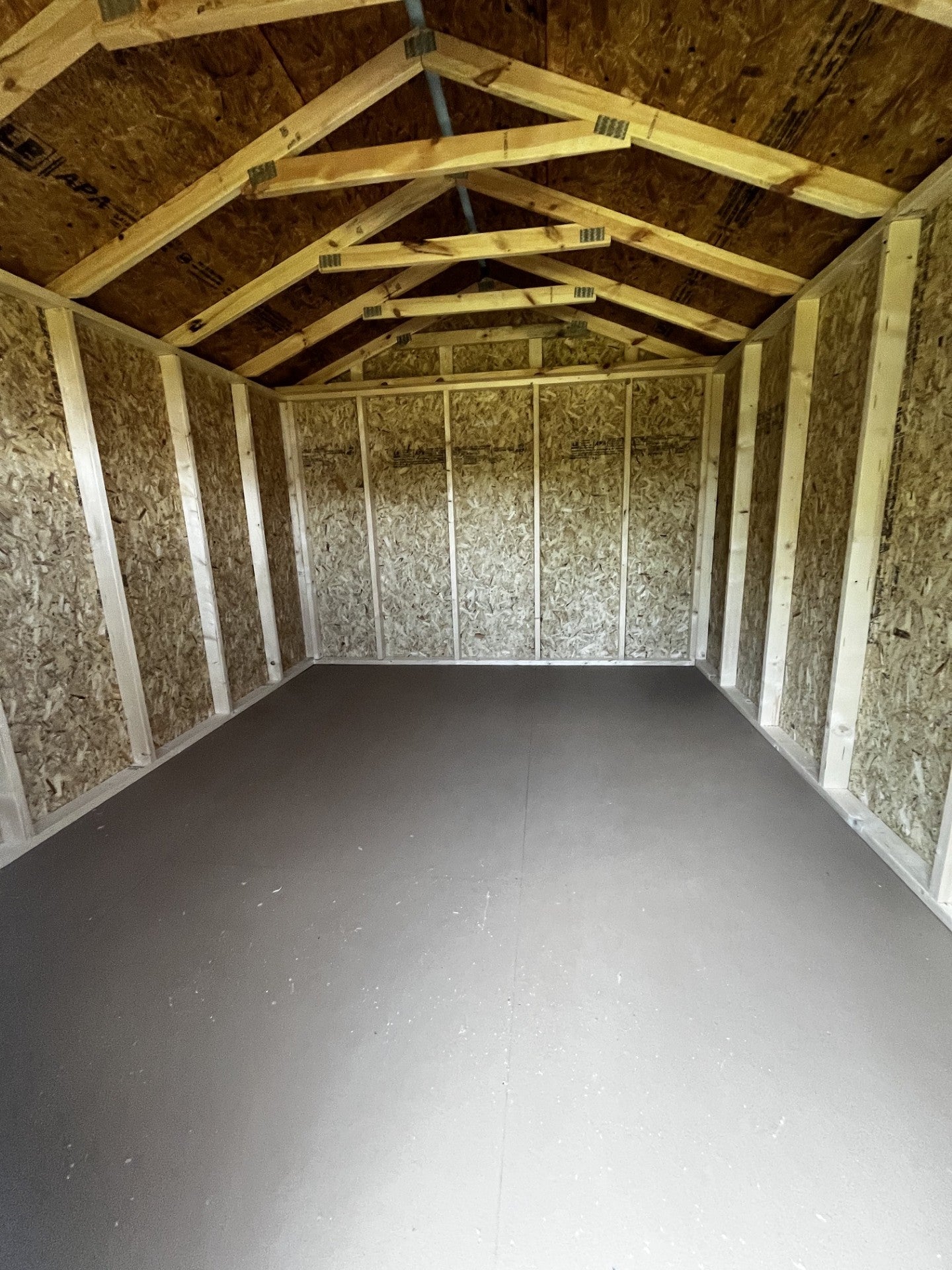 Outland Trailers 10x12 utility shed with double doors and metal siding, ideal for storage and yard organization