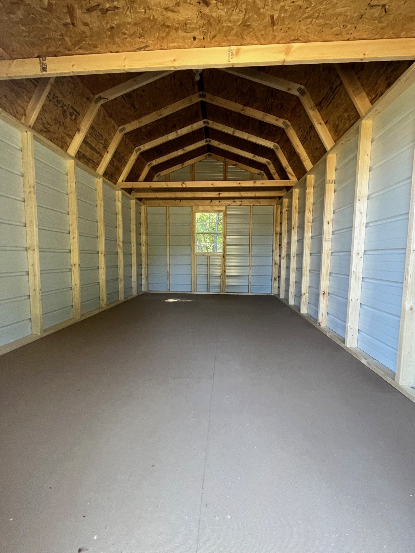 Outland Trailers 10x16 metal lofted barn with gable roof, side door, and ventilation for storage or workshop use