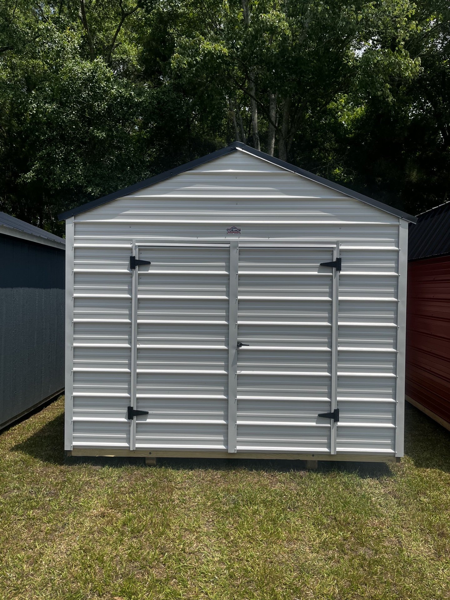 Outland Trailers 10x16 metal utility shed with double doors and vented roof, ideal for storage and outdoor organization