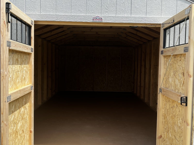 Outland Trailers 12x20 utility shed showing a sturdy metal building with double doors and a sloped roof for outdoor storage