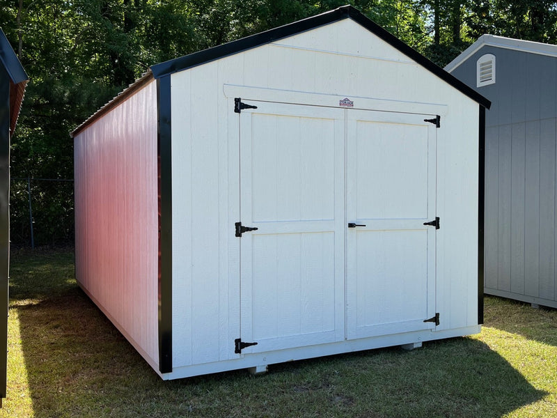 Outland Trailers 10x16 Tru-Valu Utility Shed with metal walls and double doors, shown in a backyard setting.