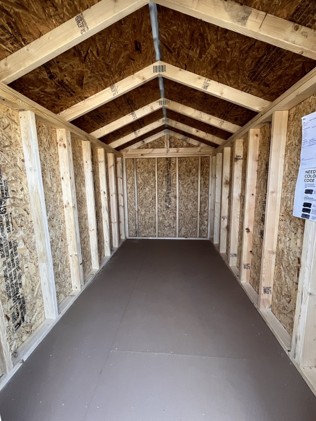 Outland Trailers 6x10 Metro Shed with metal walls and door, outdoor storage shed for tools and equipment placement.