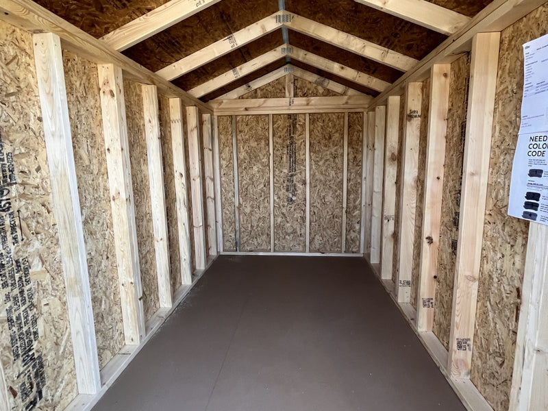 Outland Trailers 6x10 Metro Shed with metal walls and door, outdoor storage shed for tools and equipment placement.