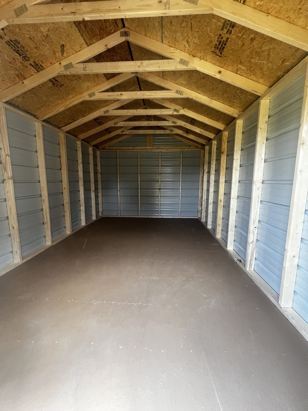 Outland Trailers 10x16 metal utility shed with sturdy construction and secure doors, ideal for outdoor storage and organization.