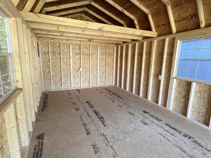 Outland Trailers 12x24 lofted garage shed with raised roof, double doors, and durable construction for storage or workshop use.
