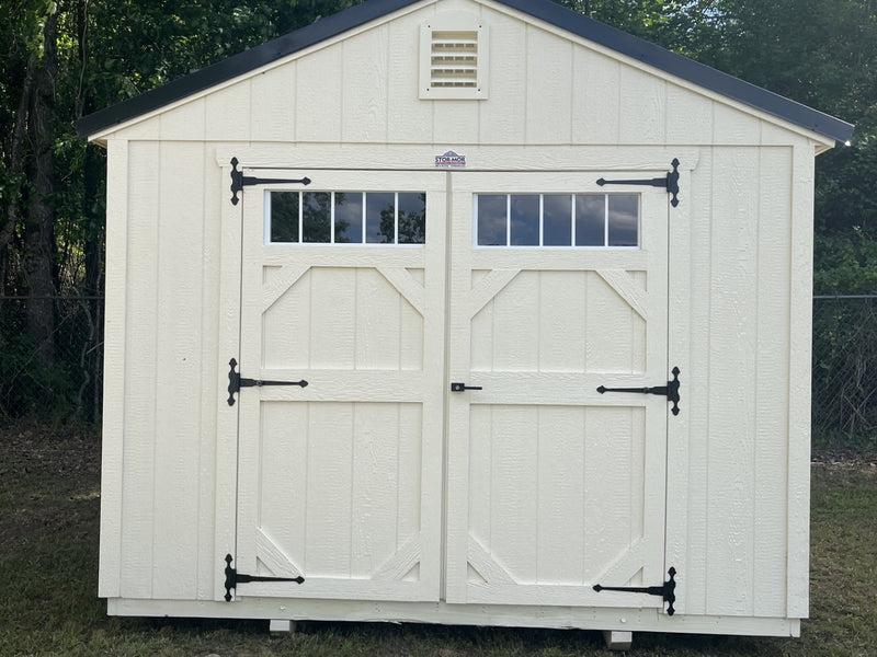 Outland Trailers 10x12 garden shed with double doors and shingle roof, ideal for outdoor storage and garden tools