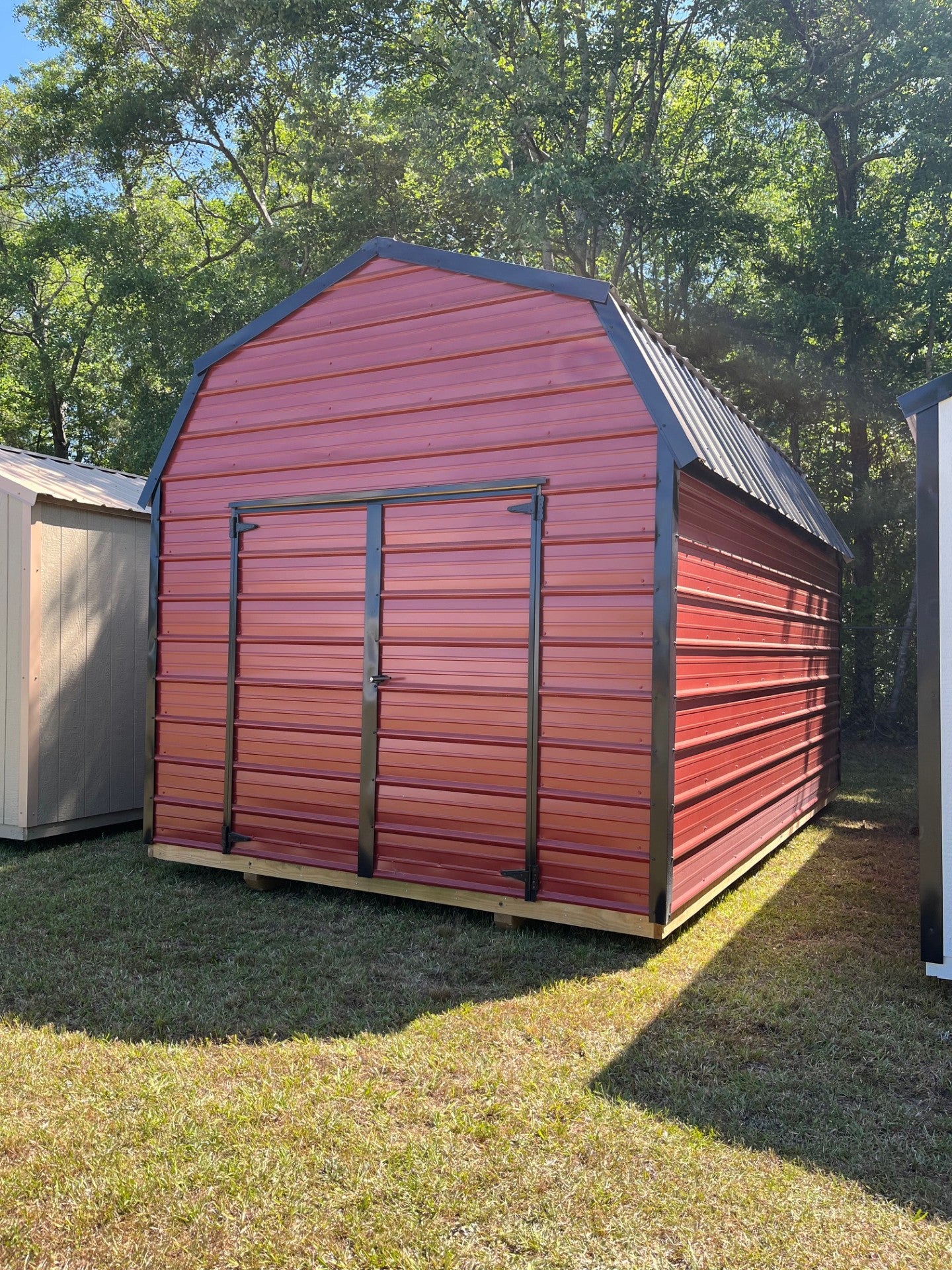 Outland Trailers 10x16 metal lofted barn with raised roof and double doors, ideal for storage or workshop use.