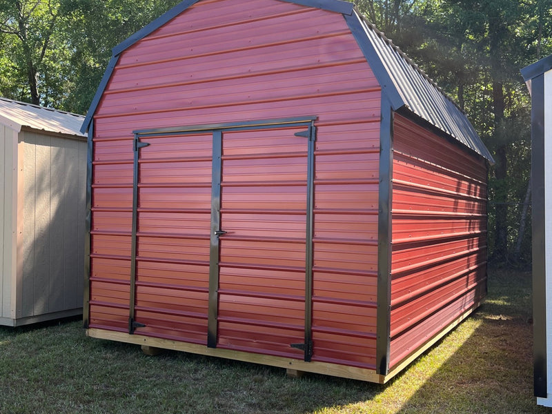Outland Trailers 10x16 metal lofted barn with raised roof and double doors, ideal for storage or workshop use.