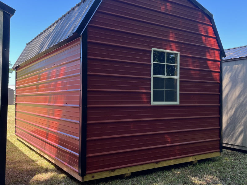 Metal lofted barn by Outland Trailers featuring a gray steel exterior, lofted storage space, and sturdy construction.