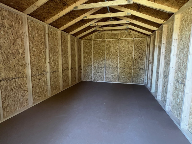 Outland Trailers 10x16 Tru-Valu Utility Shed with metal walls and door, outdoor storage solution, portable and durable construction.