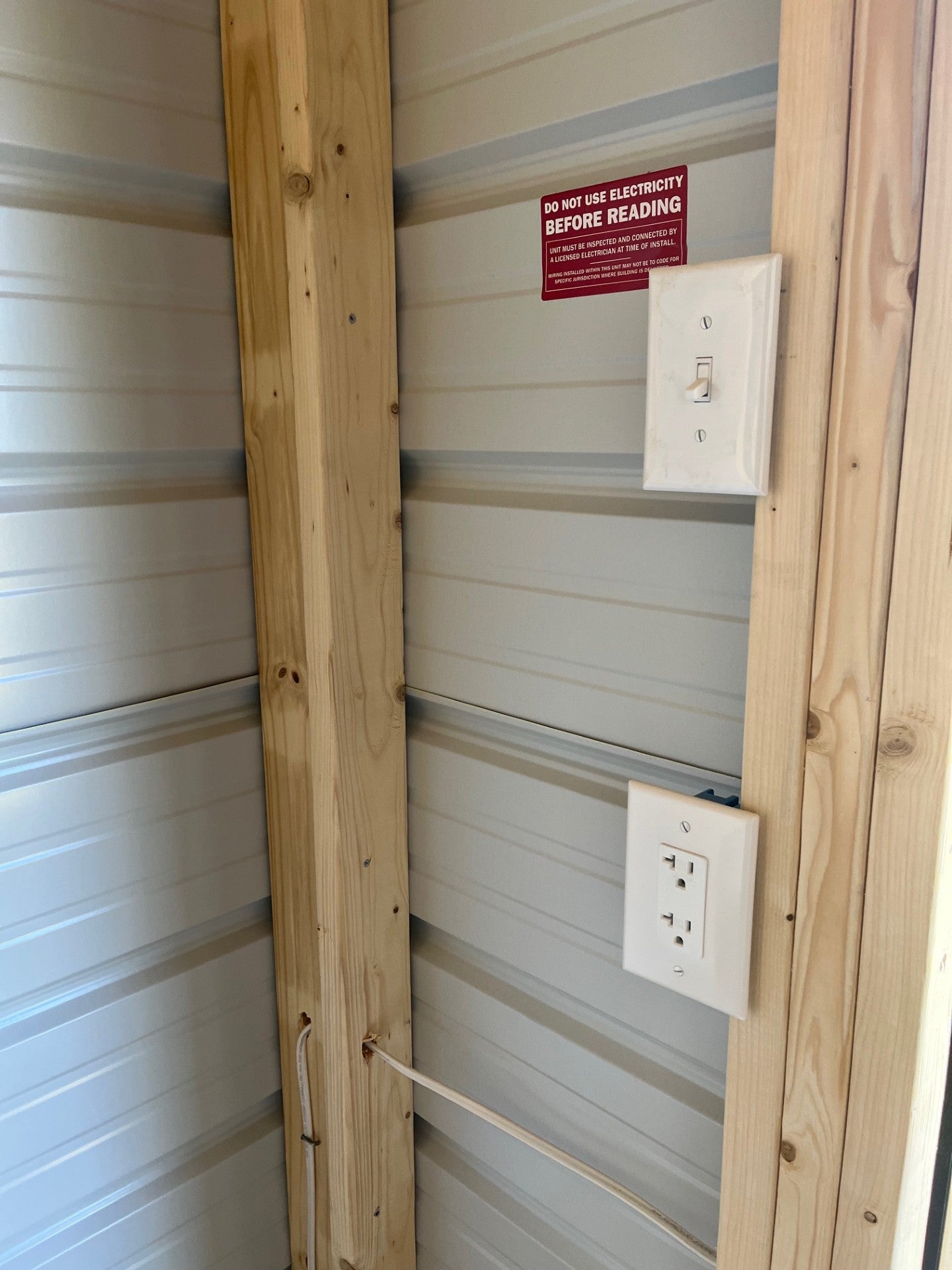 Outland Trailers 10x16 metal lofted barn showing sturdy steel construction and elevated design in outdoor setting.