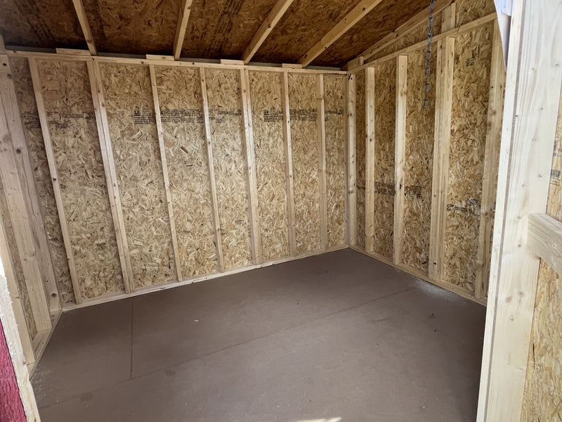 Outland Trailers 8x10 cottage shed with wooden exterior and sloped roof, ideal for storage or garden use.