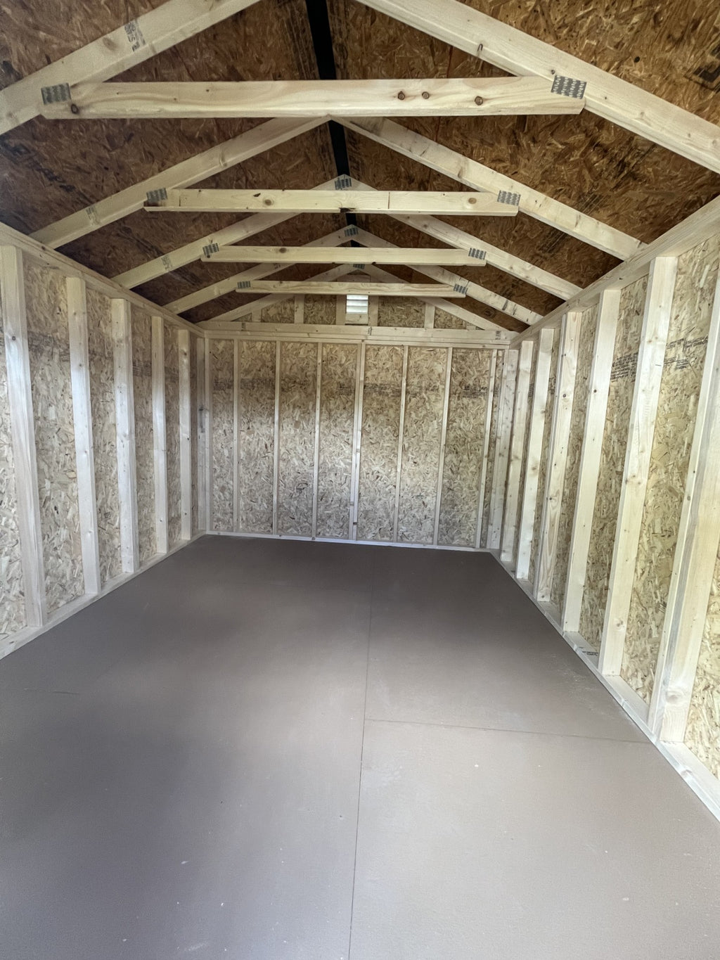Outland Trailers 10x12 garden shed with double doors and weather-resistant construction, ideal for outdoor storage solutions.