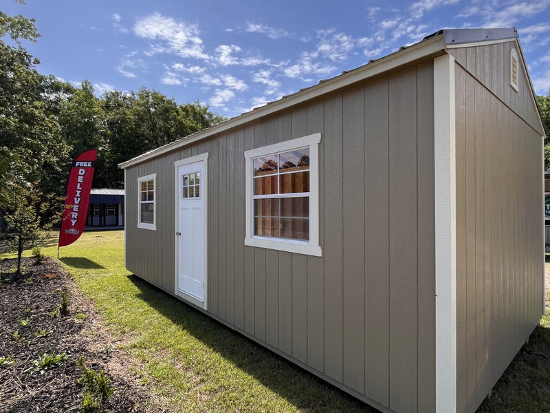 Outland Trailers 12x24 garage with metal walls and roof, large double doors, and side window for storage and workshop space.