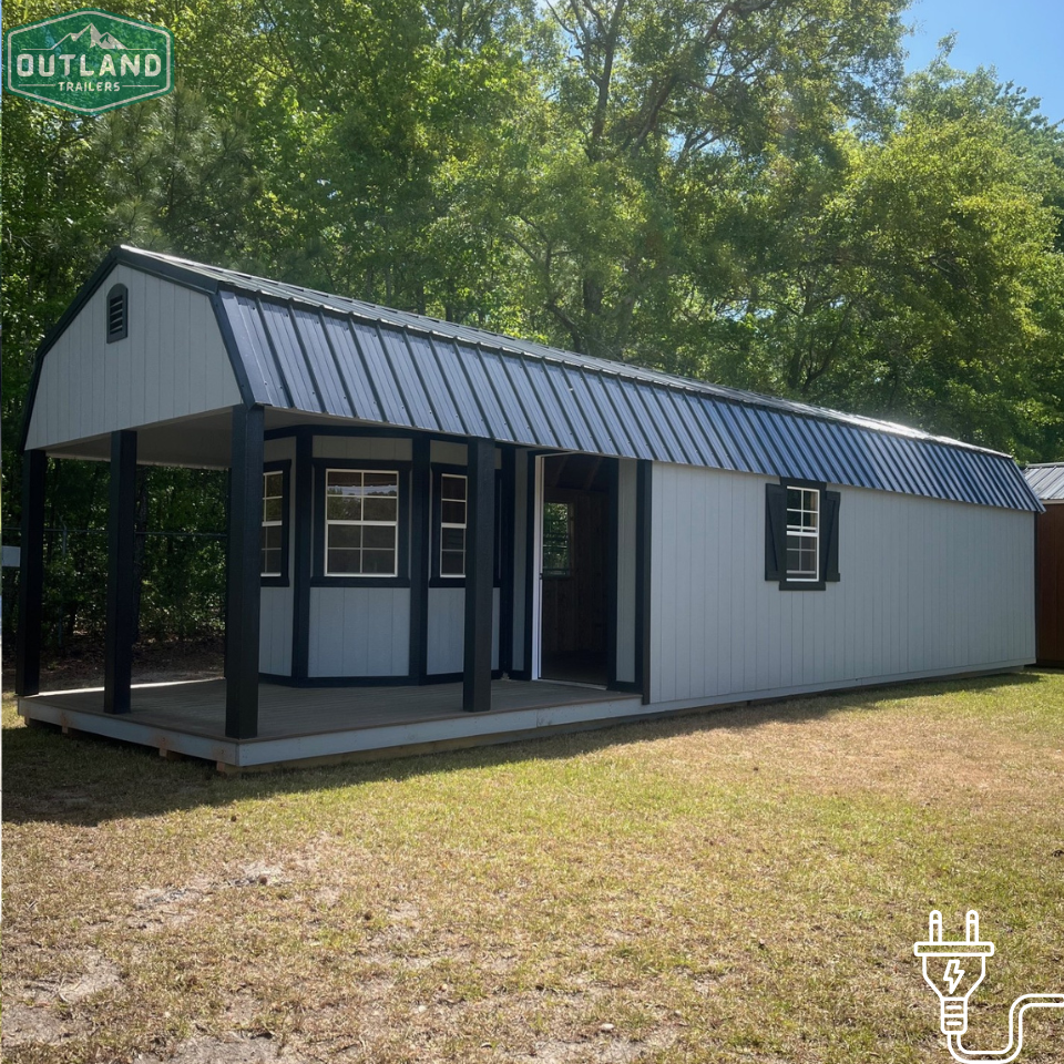 Outland Trailers 12x40 Deluxe Lofted Barn with wooden exterior and lofted storage design, ideal for storage or workshop use.