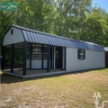 Outland Trailers 12x40 Deluxe Lofted Barn with wooden exterior and lofted storage design, ideal for storage or workshop use.