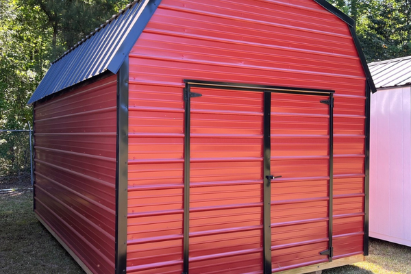 Metal lofted barn shed by Outland Trailers featuring a sturdy metal roof and elevated interior, ideal for storage or workshops.