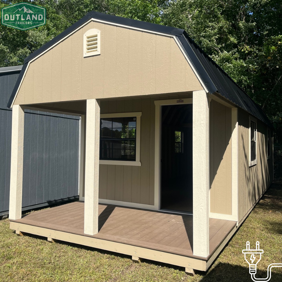 Outland Trailers 12x32 lofted barn cabin with elevated roof and wooden exterior, ideal for storage or tiny home use.