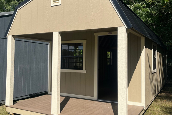 Outland Trailers 12x32 lofted barn cabin with elevated roof and wooden exterior, ideal for storage or tiny home use.