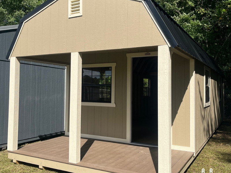 Outland Trailers 12x32 lofted barn cabin with elevated roof and wooden exterior, ideal for storage or tiny home use.