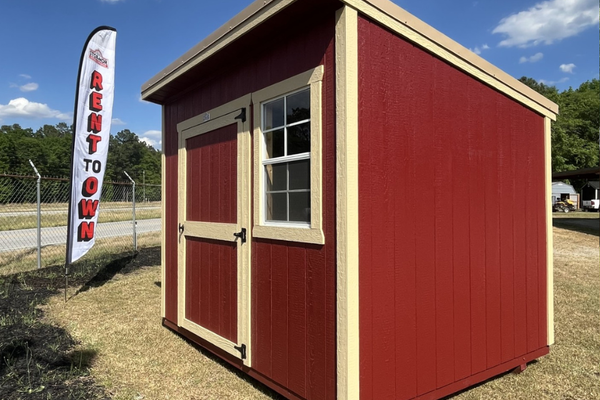 Outland Trailers 8x10 Cottage Shed with white walls and black roof, ideal for storage or small workshops.