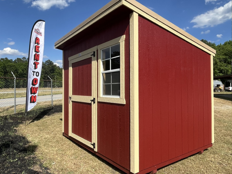 Outland Trailers 8x10 Cottage Shed with white walls and black roof, ideal for storage or small workshops.