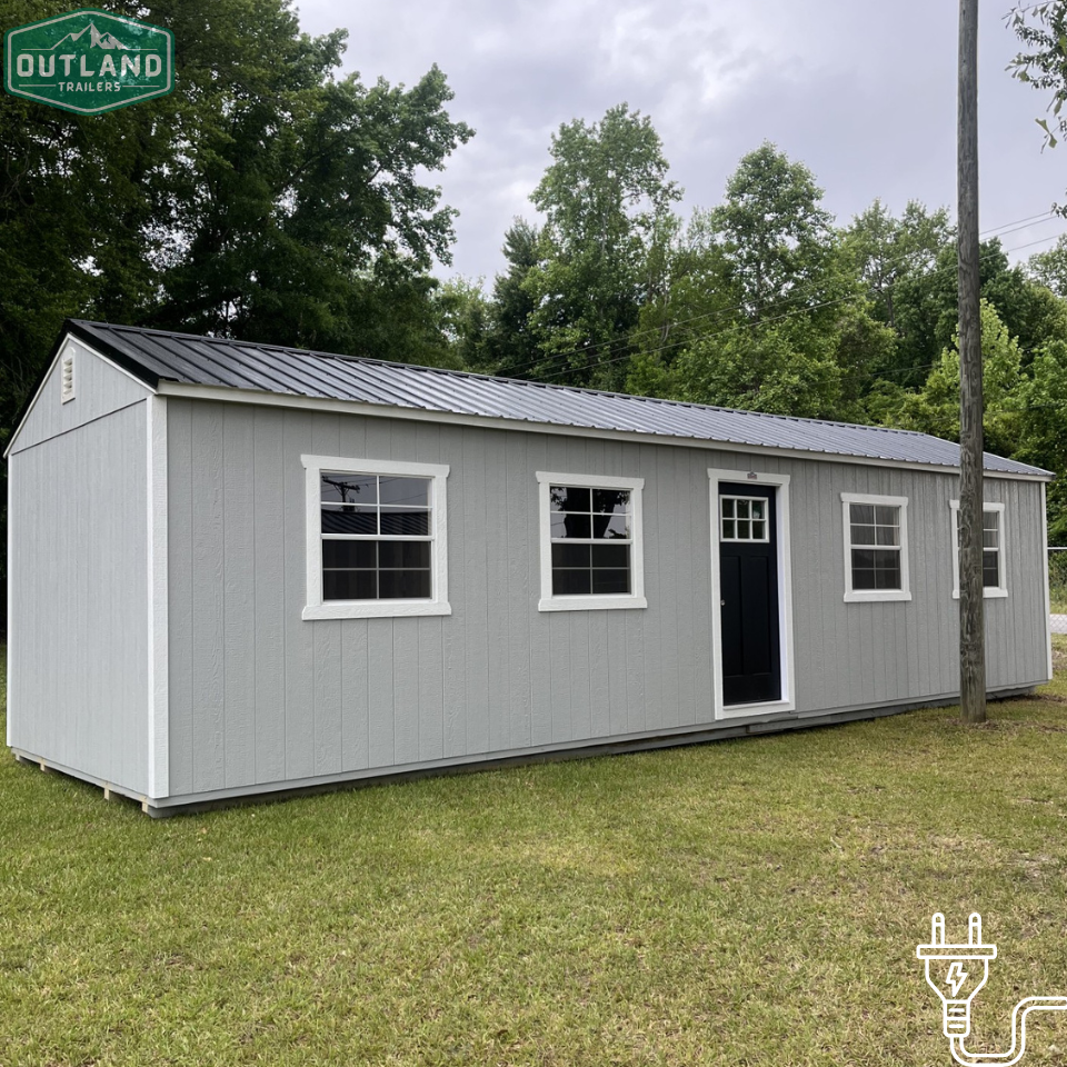 Outland Trailers 12x36 tiny home shell with wooden exterior walls and roof, ready for customization and interior finishing.