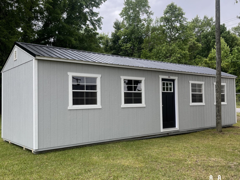 Outland Trailers 12x36 tiny home shell with wooden exterior walls and roof, ready for customization and interior finishing.