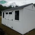 Outland Trailers 10x16 garden shed with white walls and gray roof, featuring double doors and window for outdoor storage.