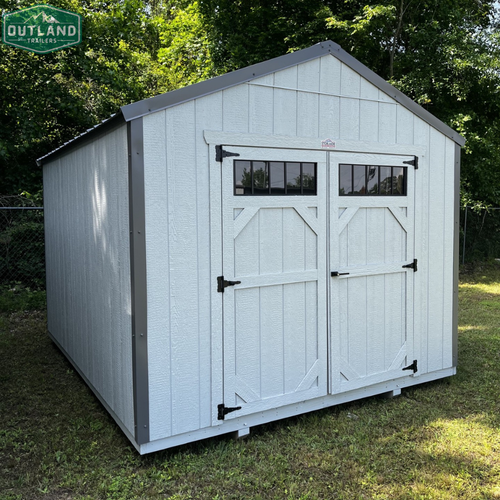 Outland Trailers 10x12 utility shed with sturdy metal construction and overhang for storage and outdoor organization.