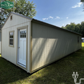 Outland Trailers 14x40 tiny home shell with wooden exterior walls and windows, ready for customization and interior finishing.