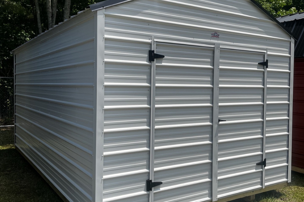 Outland Trailers 10x16 metal utility shed with double doors and vented roof, suitable for storage and outdoor use.