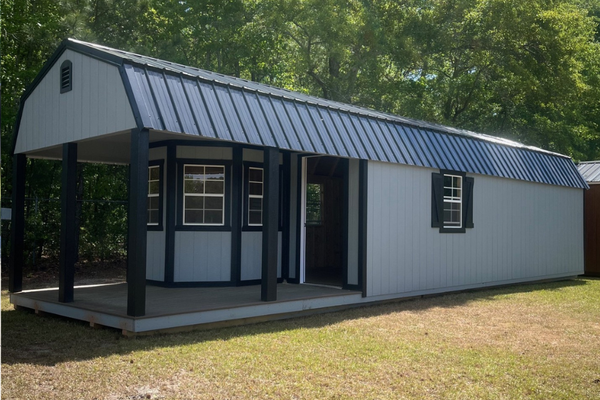 Outland Trailers 12x40 Deluxe Lofted Barn with wooden exterior and lofted storage design, ideal for storage or workshop use.