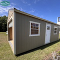 Outland Trailers 12x24 garage shed with metal roof, side door, and sturdy construction, ideal for storage or workshop use.