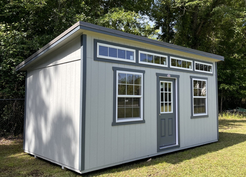 Outland Trailers 10x20 sloped studio, metal shed with sloped roof, double doors, and windows, ideal for storage or workspace.