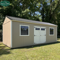 Outland Trailers 12x24 side utility shed with double doors and durable metal construction in a natural outdoor setting.