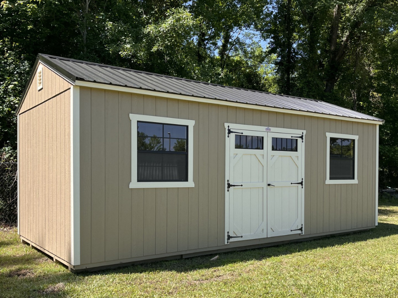 Outland Trailers 12x24 side utility shed with double doors and durable metal construction in a natural outdoor setting.
