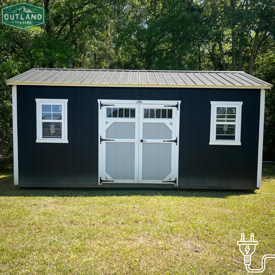 Used 12x20 Outland Trailers utility shed with double doors and metal siding, shown from the front on a gravel surface.