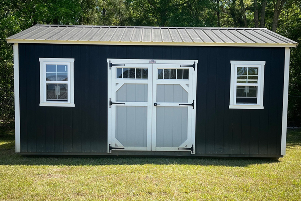Used 12x20 Outland Trailers utility shed with double doors and metal siding, shown from the front on a gravel surface.