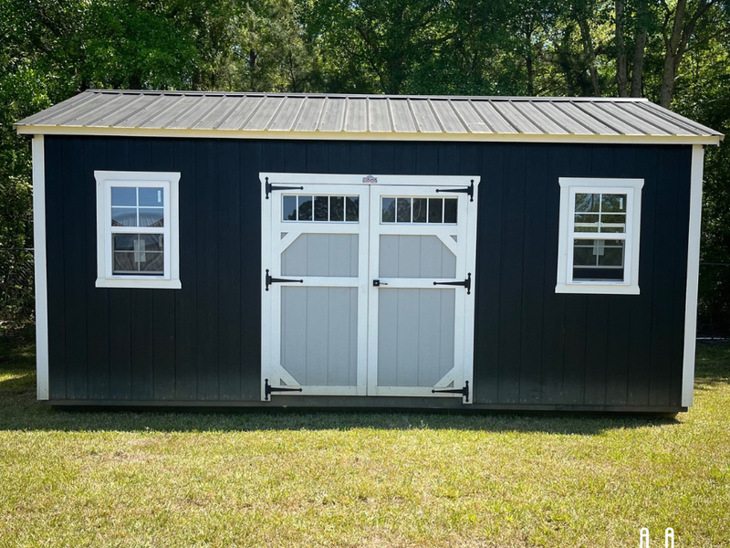 Used 12x20 Outland Trailers utility shed with double doors and metal siding, shown from the front on a gravel surface.