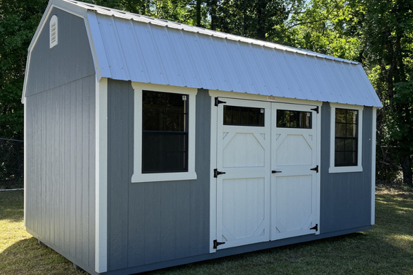 Outland Trailers 10x16 side lofted barn shed with vertical siding and double doors, showcasing durable storage design.