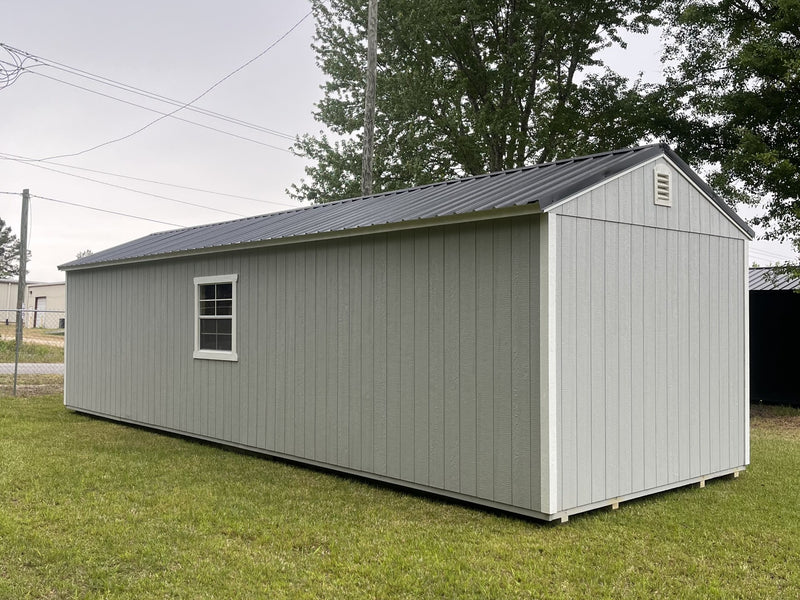 Outland Trailers 12x36 Tiny Home Shell with wooden exterior and window, ready for customization and interior finishing.