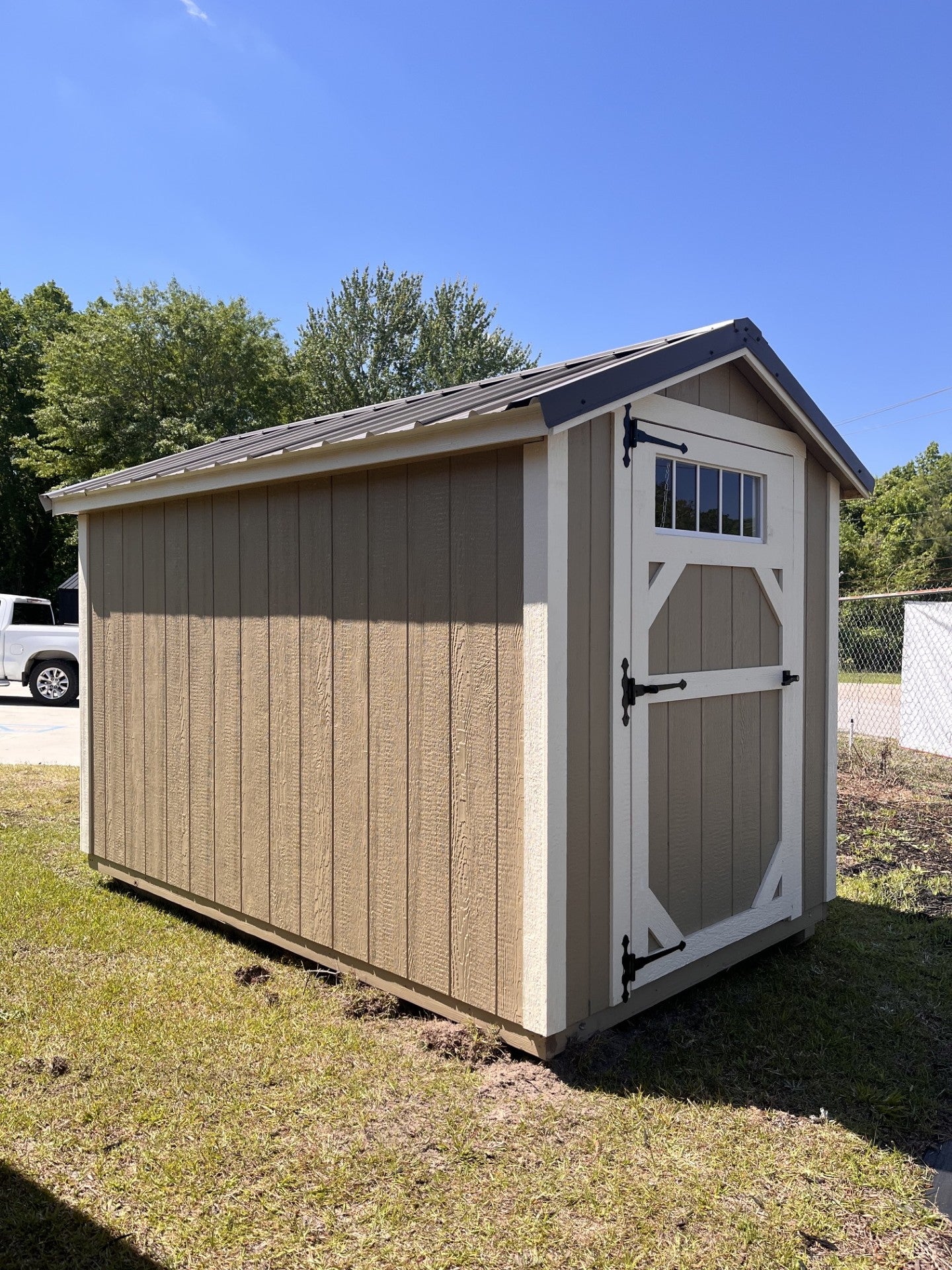 Outland Trailers 6x10 Metro Shed with metal construction, gray color, and double doors for secure outdoor storage.