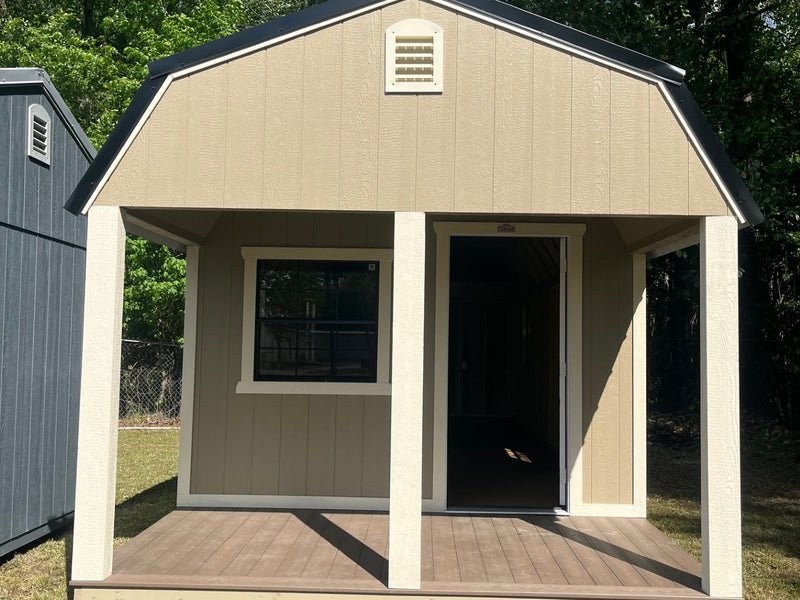 Outland Trailers 12x32 lofted barn cabin with wooden exterior, elevated design, and large front porch for outdoor relaxation.